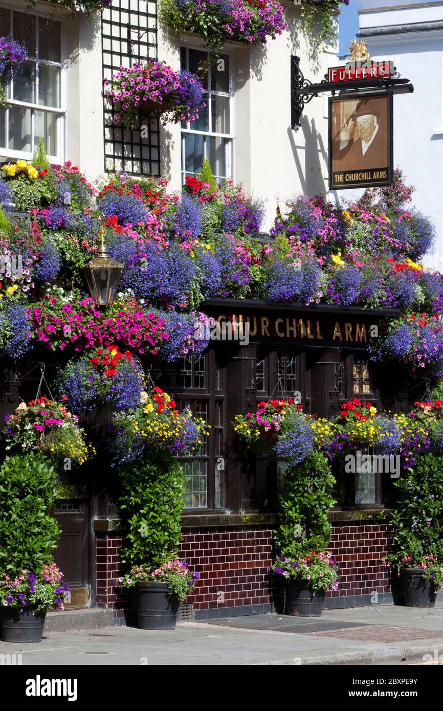 `The Churchill Arms` pub on Kensington Church Street covered in Summer flowers, London, United Kingdom Stock Photo